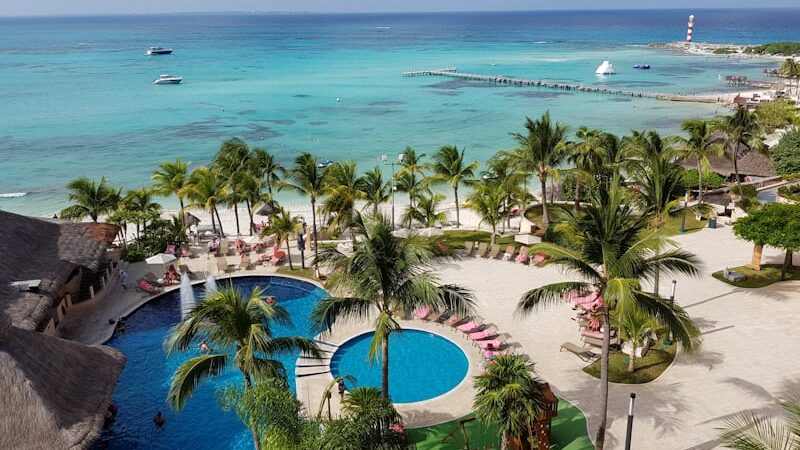Aerial view of a luxury beachfront resort in Mexico with turquoise waters and white sandy beaches.