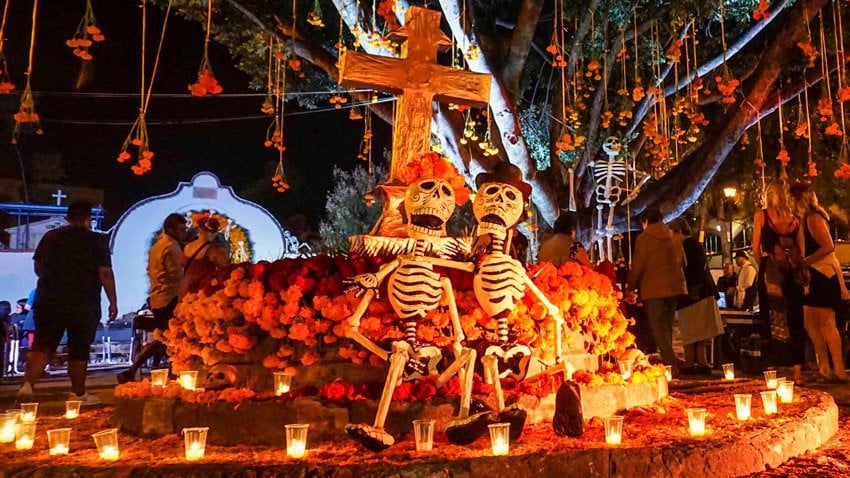  7 days in Mexico City & Oaxaca exploring traditional Day of the Dead altars decorated with marigolds and candles.
